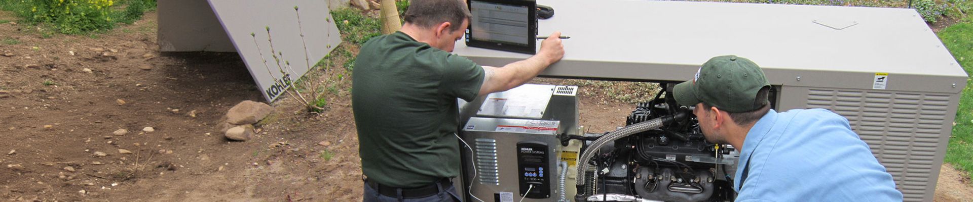 Two tower generator employees working on a residential generator