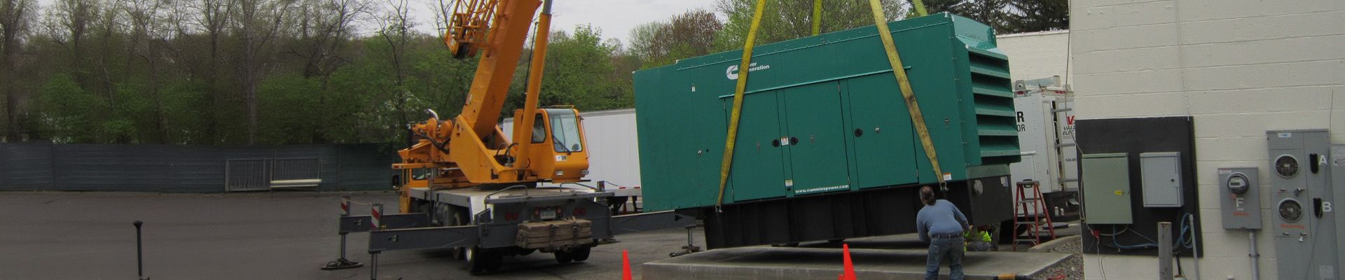 Commercial generator lifted by a crane