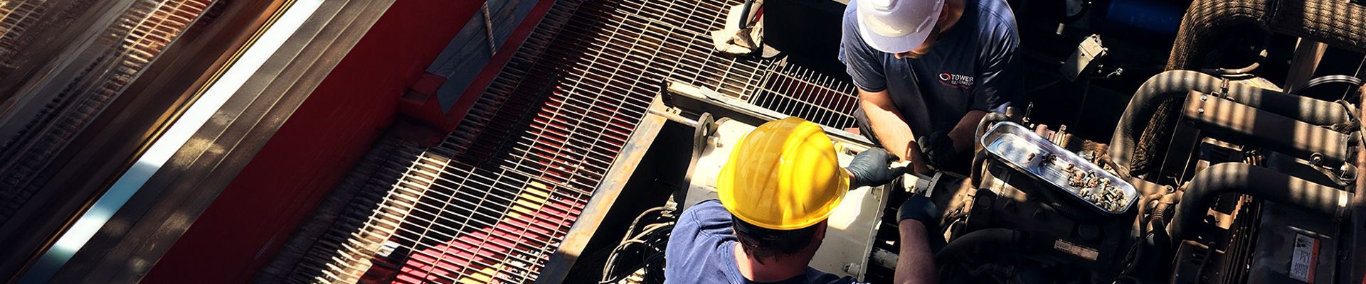 Two Tower Generator employees working on a generator